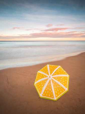 Umbrella on beach near sea