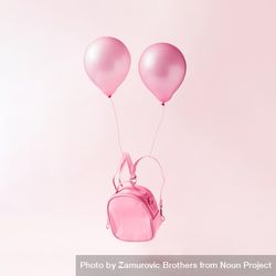 Pastel pink backpack bag with balloons floating on pink background 0LPzX0