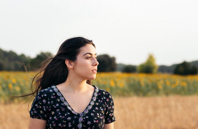 Portrait of a young woman with long hair in the countryside