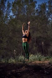 Fit woman practicing Mountain with Arms Up pose