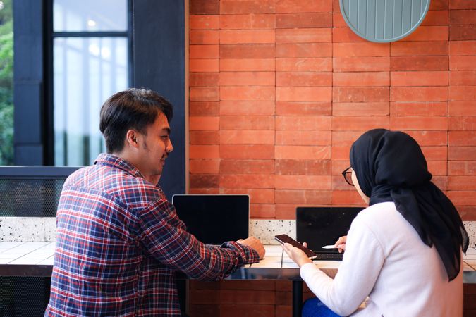 Woman and Man Young Indonesian Meeting at Cafe