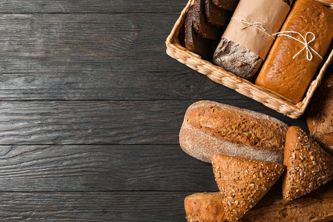 Flat lay composition with bakery products on wooden background, top view and space for text