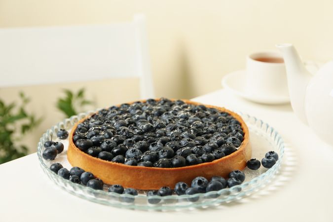 Concept of tasty breakfast with blueberry pie on table