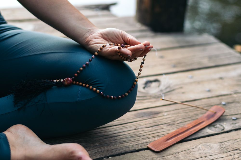 Young woman meditating and doing yoga in nature