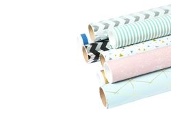 Rolls of festive wrapping paper on blank background. Space for text