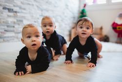 Happy babies sitting on floor