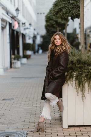 female standing on city street