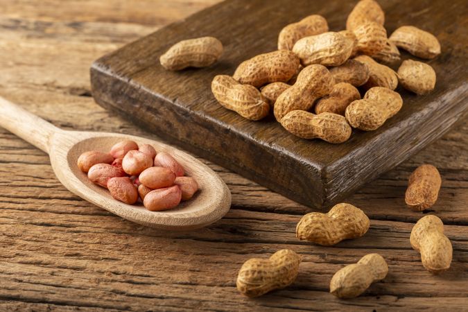 Dry peanut on the wooden background.