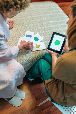Female doctor showing geometric shapes to patient