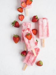 Pink popsicles and fresh strawberries