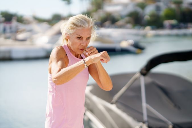 Mature woman doing sport in a coastal port
