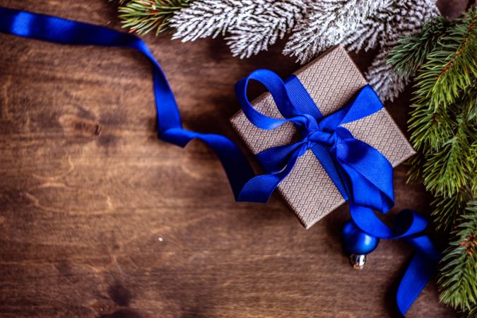 Christmas gift wrapped in blue ribbon