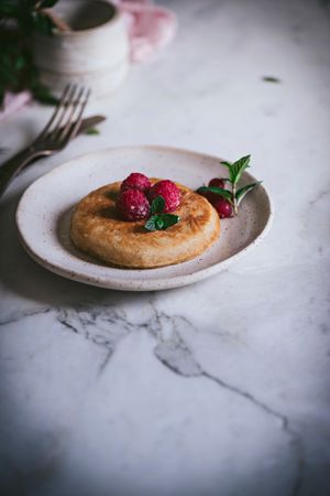 Pancake with fresh raspberry on plate