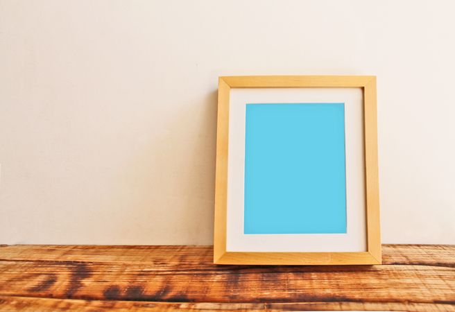 Wooden picture frame on desk mockup
