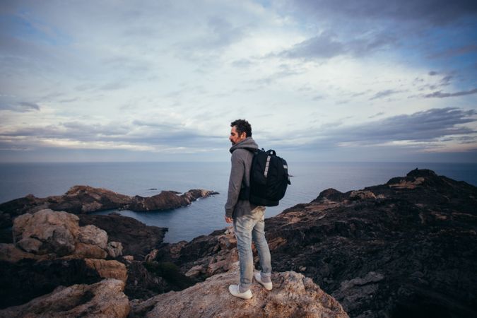 Solo trekker overlooking coast