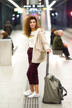 Arab woman in casual clothes with bag in metro station