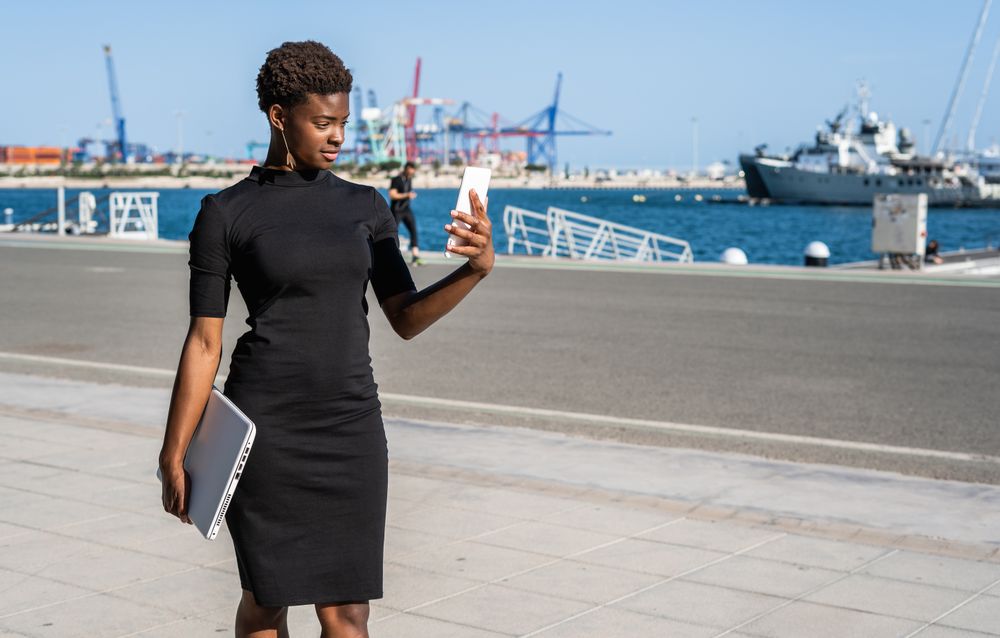Black woman using mobile phone on the street