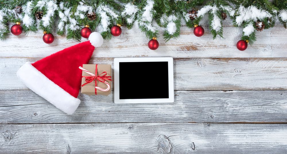 Christmas gift and technology background on rustic wood
