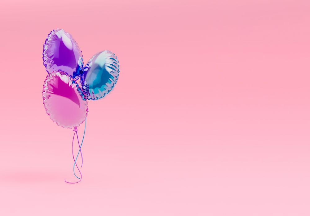 Creative Easter party with colorful balloons on pink background