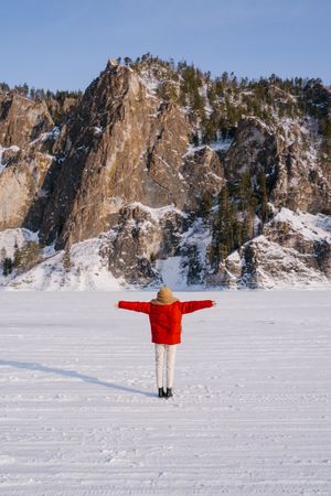 Frozen woman wrapped in scarf on winter day