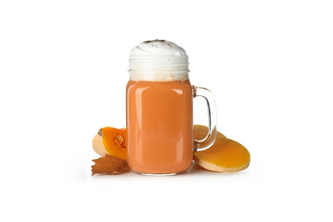 Glass cup of pumpkin latte isolated on neutral background