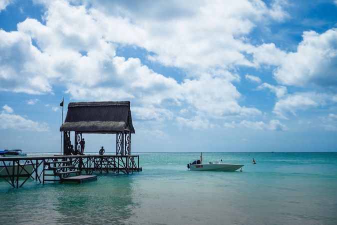 Thatched pier in Mauritius with small boat