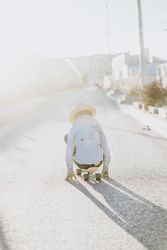 Stylish girl with skateboard on street