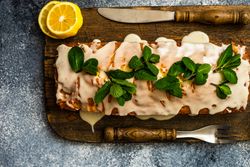 Top view of freshly baked lemon cake dessert on wooden board