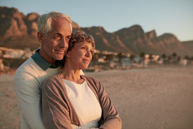 Portrait of couple standing together and embracing on the beach
