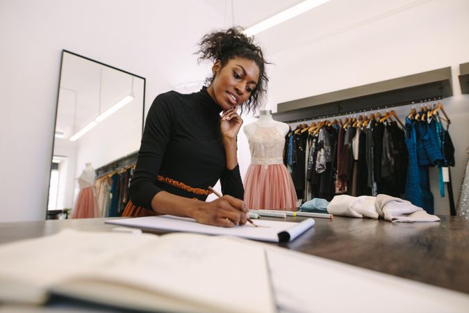 Black entrepreneur making a drawing at her desk