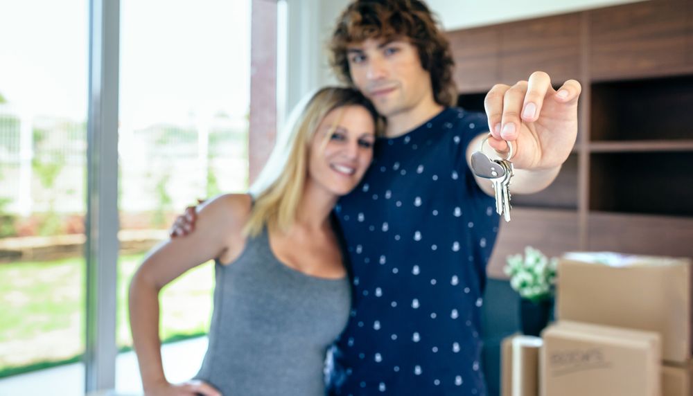 Moving couple showing keys