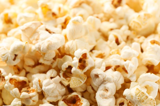 Delicious popcorn on whole background, close up