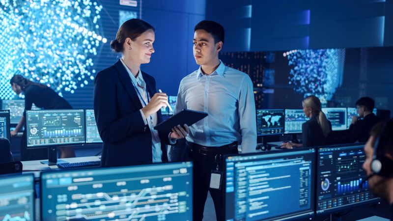 Professionals Collaborate in High-tech Monitoring Center.