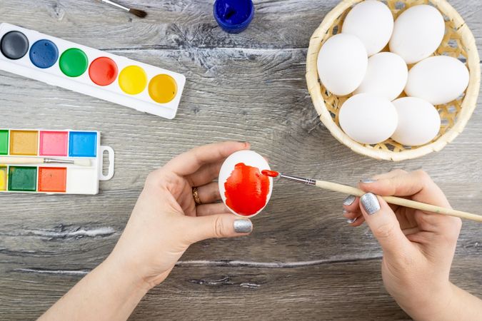 Woman coloring eggs