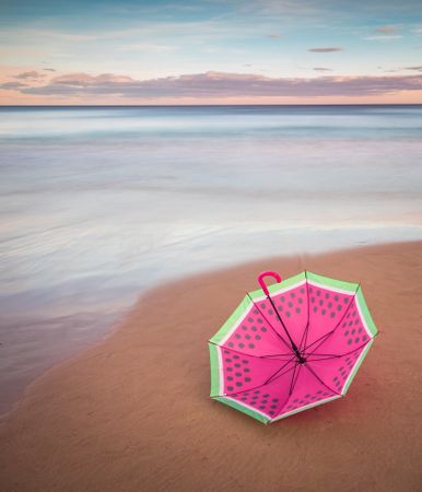 Umbrella on beach near sea