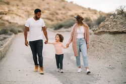 Stylish multiethnic family walking on nature
