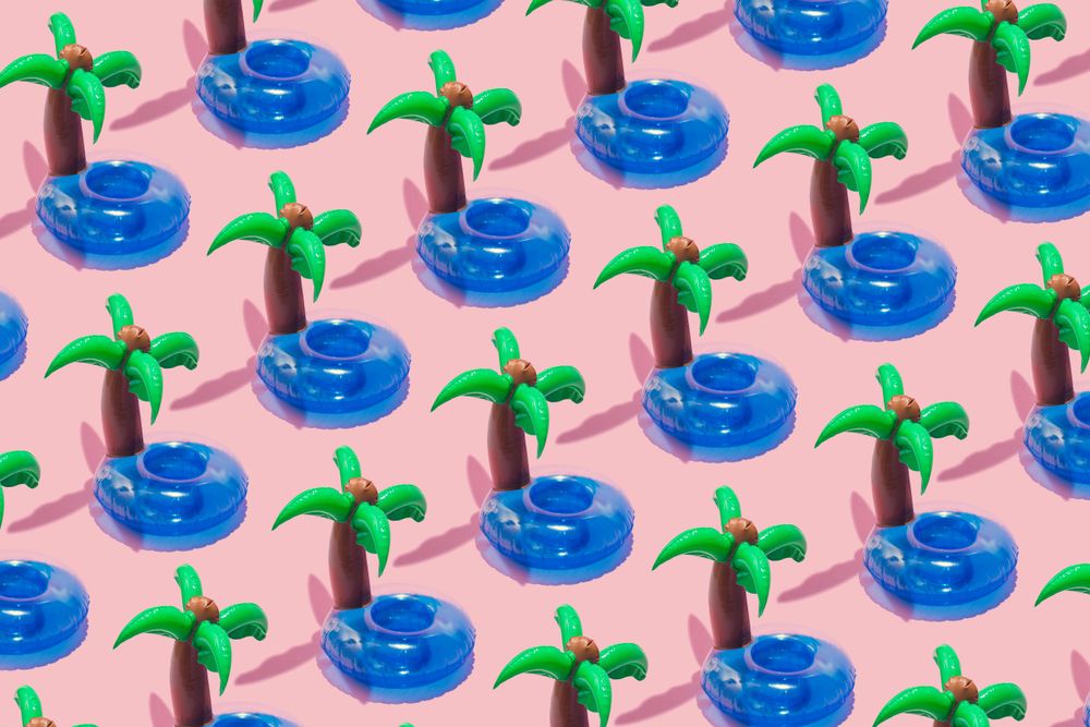 Tropical palm inflatable toy pattern on pink background
