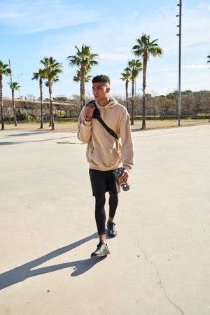 Full body of Latino man with equipment for outdoor training