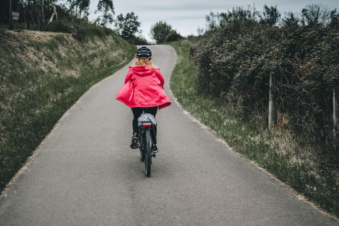 Female riding bicycle in countryside road