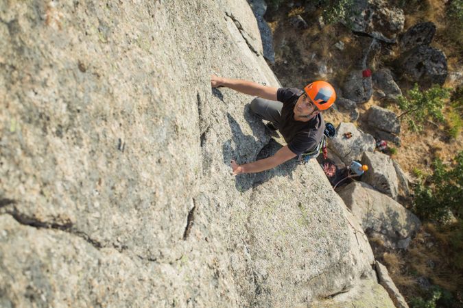 Climbers in safety harness climbing mountain