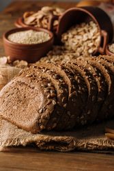 Freshly baked rye bread on napkin on table