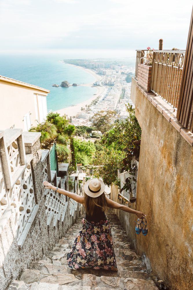 Stylish woman picturing coast from stairway