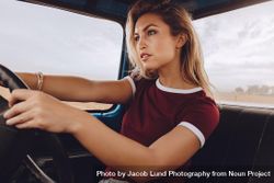 Young woman driving a car bDRJQ5