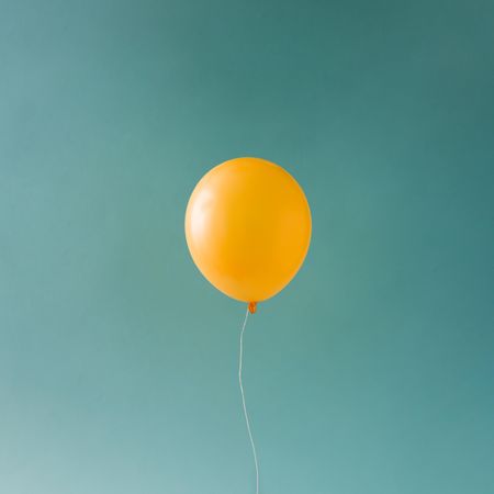 Yellow balloon on blue sky