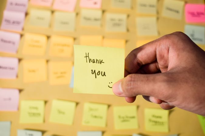 Hand hold sticky notes with words Thank you