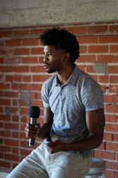 Man public speaking intently with microphone