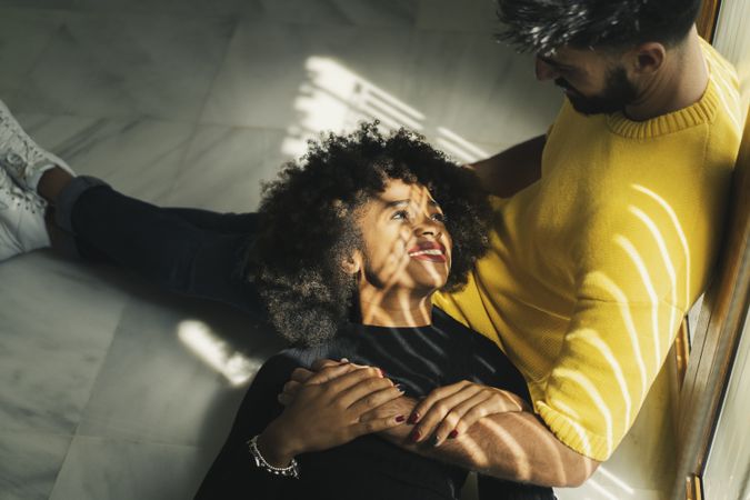 Black woman lying on knees of boyfriend