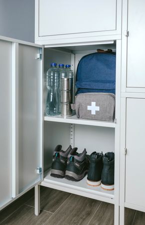 Emergency backpack and first aid kit kept in a closet