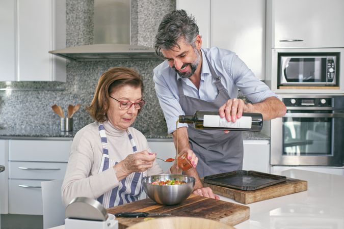 Son helping woman to make filling