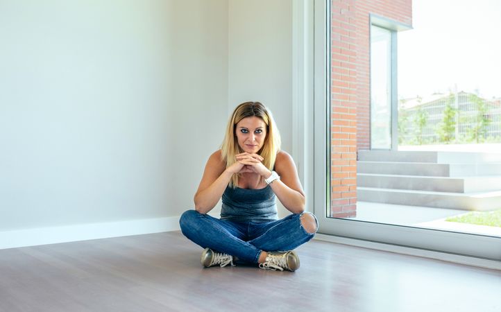 Thoughtful woman sitting in a living room